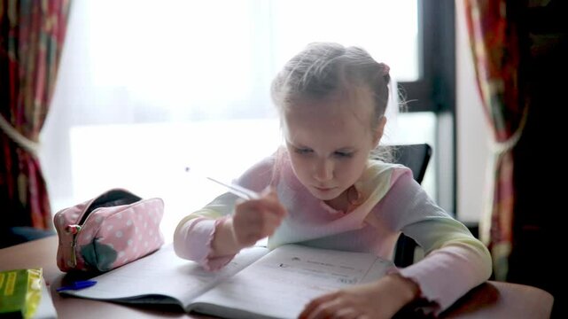 Schoolgirl doing her homework at home