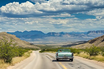Classic car cruising down a scenic highway in the mountains on a sunny day under a blue, cloud-filled sky. Generative AI