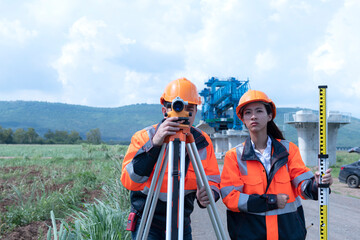 Surveyors working at new construction site. construction worker on a site. Surveyor engineers using...