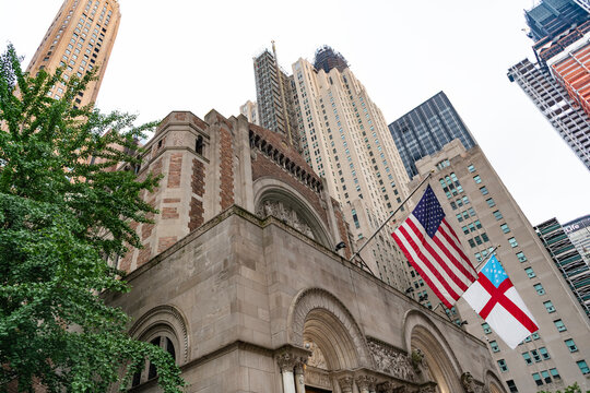 City downtown with skyscraper and Episcopal church. Architecture. Building architecture. Skyscraper and church with American flag. Modern building in metropolis city. Building skyscraper in city