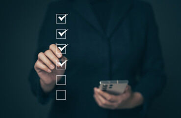 Business performance checklist concept Young business woman using laptop surveys online checklist Complete the digital form checklist via the internet...