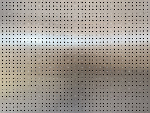Close-up of Perforated Metallic Surface - Detailed Industrial Texture