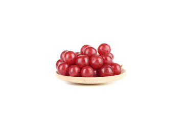 Ripe viburnum berries on a serving wooden plate on a white background.