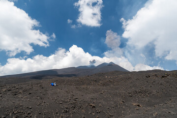 Couple tourist getting lost in  Mount Etna, active stratovolcano in Catania, Sicily region. It is...