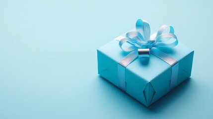 Obraz premium A beautifully wrapped blue gift box with a ribbon, symbolizing celebration and giving.