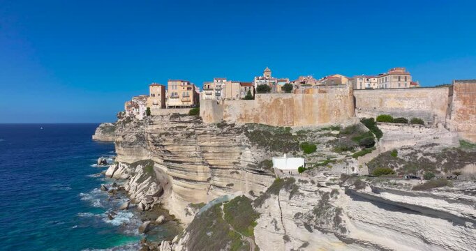 Drone flight along dramatic limestone cliffs of the historic town of Bonifacio on Corse island