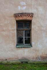 Old wooden window on the ancient abandoned house