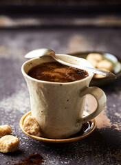 Mug of coffee on rustic wooden background. Copy space.