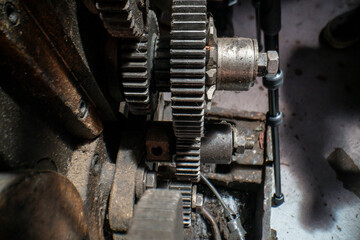 A close-up of industrial metal gears showcases precision engineering and mechanical design. The...