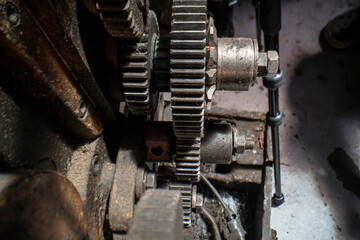 A close-up of industrial metal gears showcases precision engineering and mechanical design. The intricate machinery parts highlight the complexity of industrial manufacturing processes and technology.