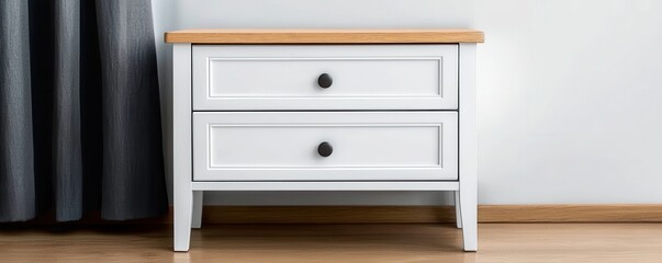 A stylish white nightstand with two drawers and a natural wood top, complementing modern decor in a cozy room setting.