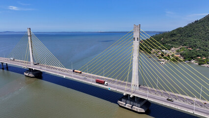 Fototapeta premium Scenic Viaduct At Laguna In Santa Catarina Brazil. Cable Bridge Landscape. Freeway Road. Seascape Background. Scenic Viaduct At Laguna In Santa Catarina Brazil. Winding Bridge. 