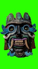 wooden painted tiki mask with gren background