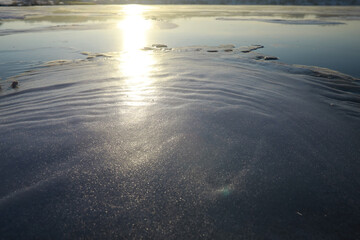 Obraz premium Ice ax - ice screws on winter fishing on the ice caves. Ice is very clean and beautiful. The Lake Baikal.