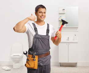 Man from a plumbing service using a plunger for a clogged toilet