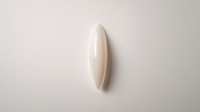 A Smooth, Iridescent Gemstone Cabochon on White: Minimalist Elegance
