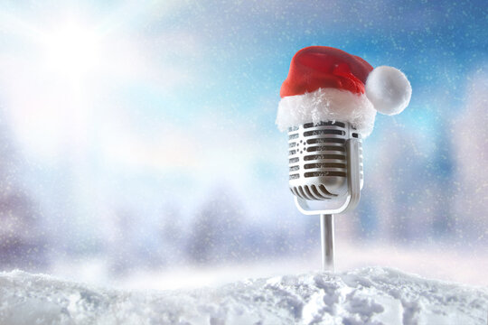 Vintage microphone with Santa hat in snowy landscape - Powered by Adobe
