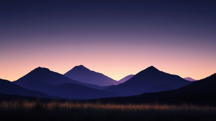 Silhouetted mountains at dusk, showcasing a gradient of purples and oranges in the sky.