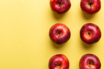 Many red apples on colored background, top view. Autumn pattern with fresh apple above view with copy space for design or text