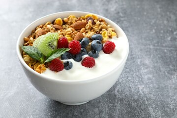 Delicious granola with berries and yogurt on the table