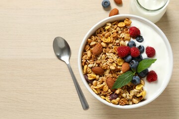 Delicious granola with berries and yogurt on the table