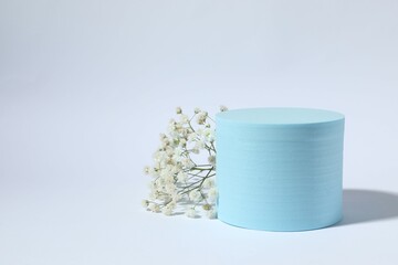 Podium and white gypsophila flowers on a white background