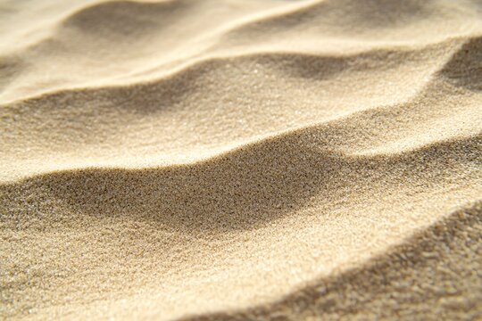 Papier peint en texture de sable beige fin avec un aspect granuleux naturel..