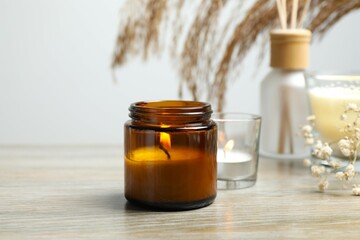 Aromamic candle burning on table
