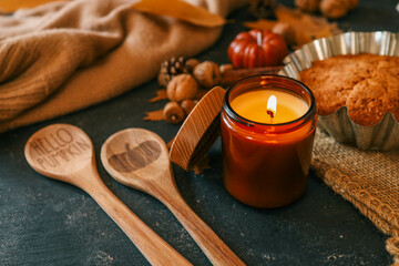 Burning candle with pumpkin pie scent, cozy autumn