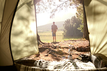 Back, man and tent for camping outdoor with view, summer vacation and nature getaway of adventure. Male person, relaxing and shelter security, trekking peace and holiday location with tourism explore