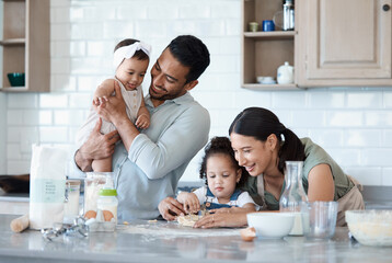 Happy family, children and baking with cookie cutter to shape dough, flour and carrying baby in kitchen. Mom, dad and kids cooking with parents, help and teaching dessert recipe for support in home