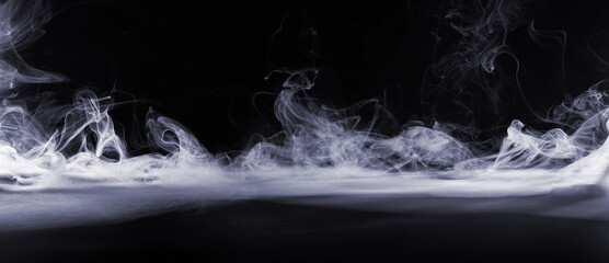 Abstract image of dark room concrete floor. Black room or stage background for product placement.Panoramic view of the abstract fog. White cloudiness, mist or smog moves on black background. 