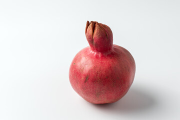 Ripe pomegranate on a white background