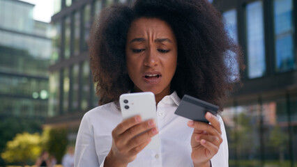Sad upset African American woman girl businesswoman business user mobile phone smartphone bank card...