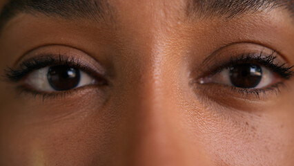 Close up dark eyes African American woman female face girl vision businesswoman eyesight sight see looking at camera makeup health medicine laser correction business ophthalmology cropped view city