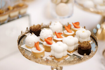 Sweet cakes with filling on a stand on the buffet table.