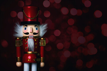 Close up of christmas wooden nutcracker toy soldier with christmas lights and space for text....
