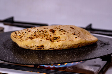  The process of cooking traditional Caucasian tortillas with stuffing (khychiny) with mashed potatoes, cottage cheese and herbs.