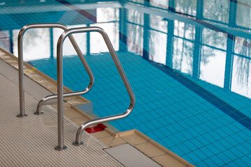 Modern Indoor Pool with Sleek Railing and Clear Blue Water