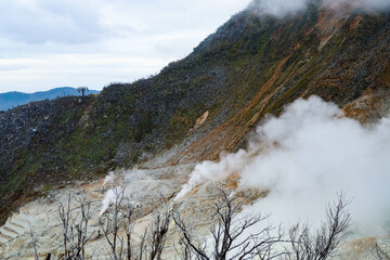 Owakudani, Japan- 29 Oct 2024: the volcano mountain with smoke and cable cars along the mountain...