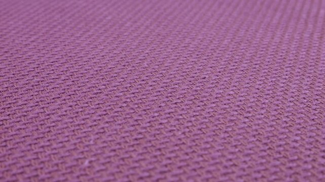 Cotton fabric background in violet color with a shade of heather on a rotating display case. Textile fabric with texture and pattern of fabric. Sewing, fashion and clothing design.