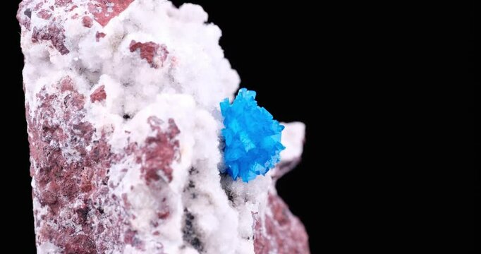Cavansite crystals on stilbite rotating footage. isolated on black background. Specimen from Wagholi, India. macro detail close-up mineral crystal unpolished semi-precious gemstone.