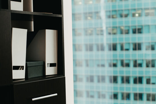 Office folders against the background of a skyscraper window.