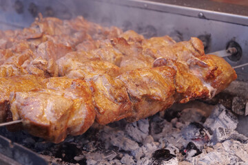 Kebabs on skewers are grilled on hot coals