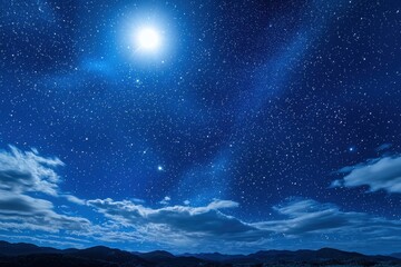 Naklejka premium A stunning night sky filled with stars and a bright moon, showcasing the beauty of the cosmos over a mountainous landscape.