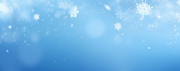 Fototapeta premium A serene blue background with falling snowflakes, evoking a winter atmosphere.