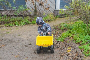 a child boy on a wheeled bulldozer tractor, photo without filters