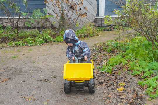 a child boy on a wheeled bulldozer tractor, photo without filters