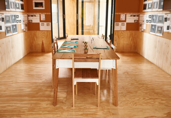 Empty meeting, wooden or boardroom for business, corporate discussion or brainstorming. Modern furniture, interior design or table with documents or chairs for collaboration, planning or development