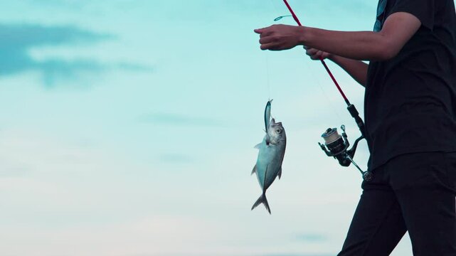 A man managed to catch a trevally using a fishing rod